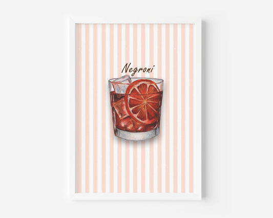 A framed art print featuring a watercolour illustration of a Negroni cocktail in a tumbler glass with ice and an orange slice garnish, set against a background of vertical coral and white stripes. The print is shown in a white frame against a light grey wall.