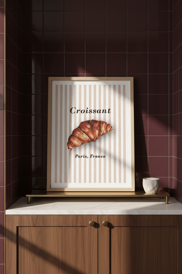 Croissant art print in a pale oak frame, displayed in a contemporary home coffee bar with burgundy tiles and walnut cabinetry.