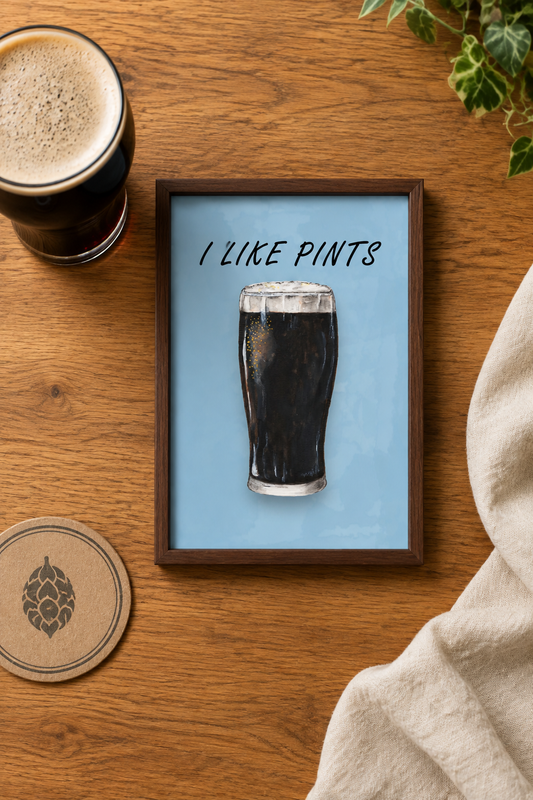 Flat-lay of the framed A5 I Like Pints print with a pint and beer mat