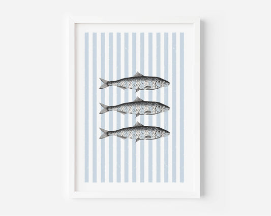 A framed art print featuring three horizontal fish illustrations over vertical light blue and white stripes, displayed in a white frame against a light gray wall.