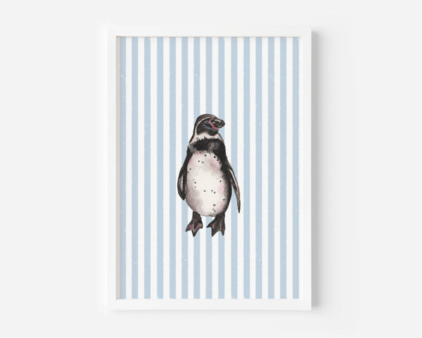 A framed art print featuring a watercolor illustration of a penguin centered on a background of light blue and white vertical stripes, displayed against a clean white wall.