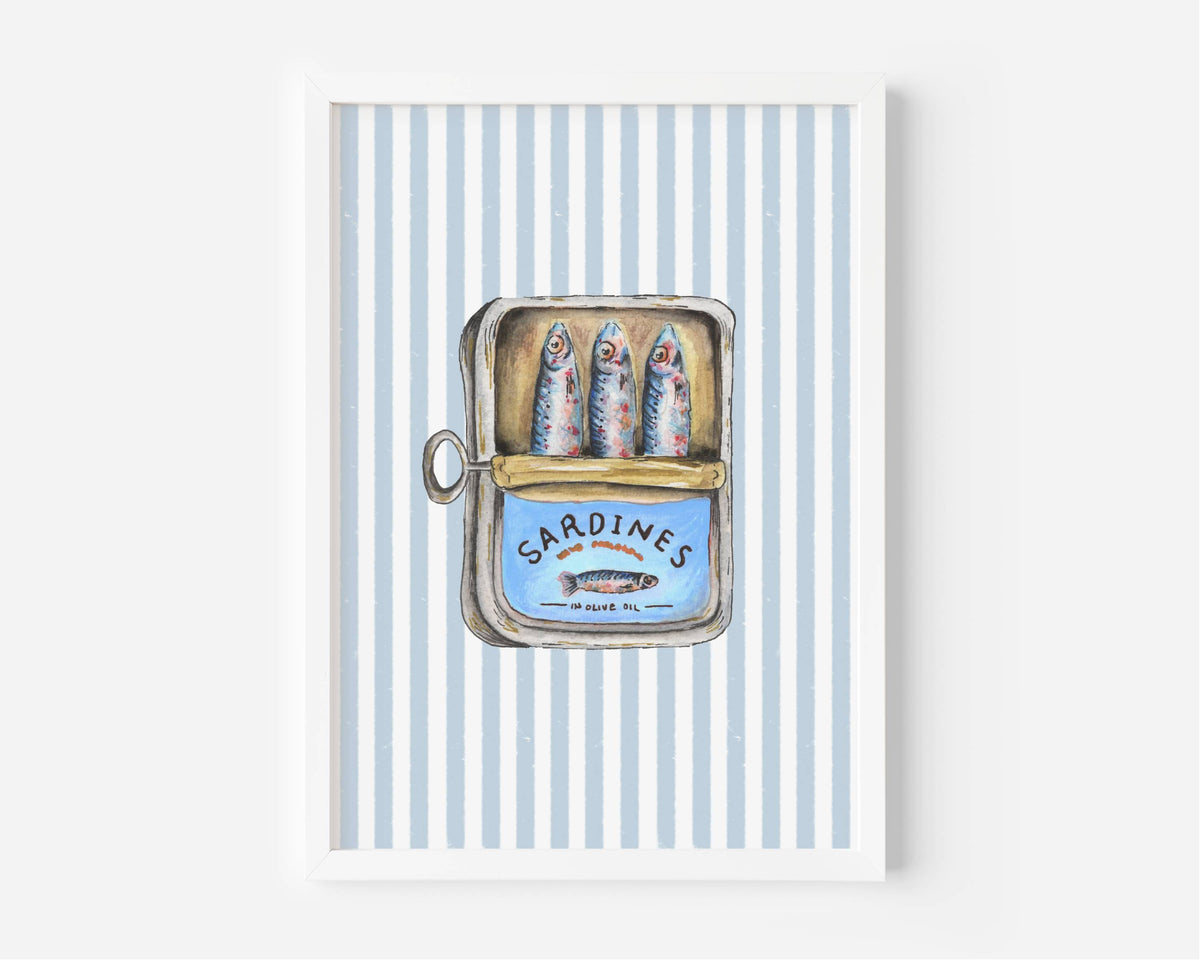 A framed art print featuring a vintage-style illustration of three sardines inside an open tin can labeled 'SARDINES', set against a background of light blue and white vertical stripes.