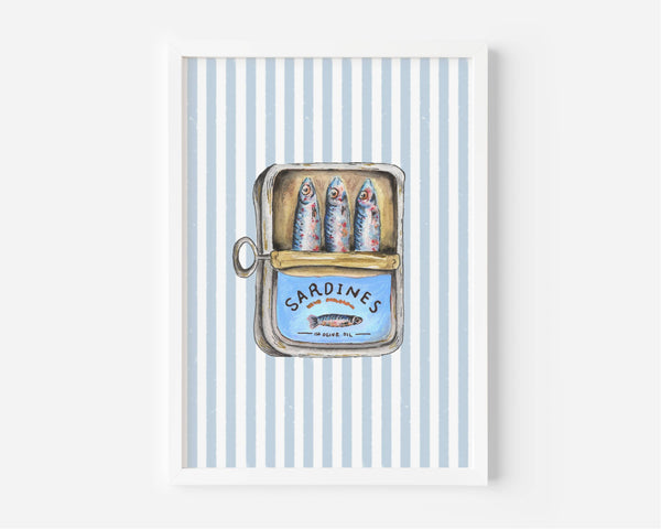 A framed art print featuring a vintage-style illustration of three sardines inside an open tin can labeled 'SARDINES', set against a background of light blue and white vertical stripes.