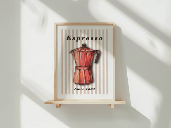 A framed art print featuring a vintage red espresso moka pot on a cream striped background with the text 'Espresso' and 'Since 1881', displayed on a small wooden stand against a white wall with soft window shadows.