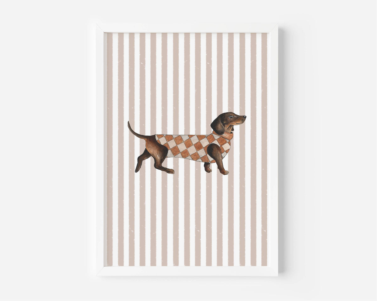 A framed art print featuring a brown dachshund wearing an orange and white argyle sweater, set against a background of vertical beige and white stripes.