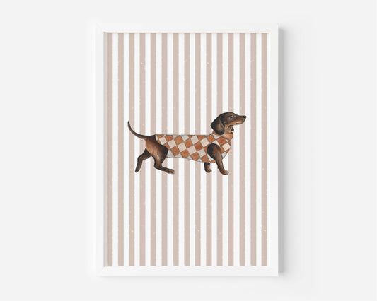 A framed art print featuring a brown dachshund wearing an orange and white argyle sweater, set against a background of vertical beige and white stripes.