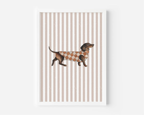 A framed art print featuring a brown dachshund wearing an orange and white argyle sweater, set against a background of vertical beige and white stripes.