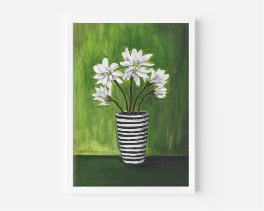 A framed art print depicting white flowers in a black and white striped vase against a textured green background, shown on a clean white wall.