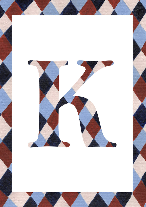 A decorative letter K monogram with a harlequin diamond pattern in navy, light blue, burgundy, and cream, set against a white rectangular field with a matching patterned border.