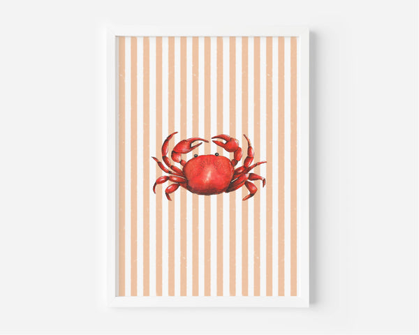 A framed art print featuring a red watercolor crab centered on a background of vertical peach and white stripes, displayed against a light gray wall.