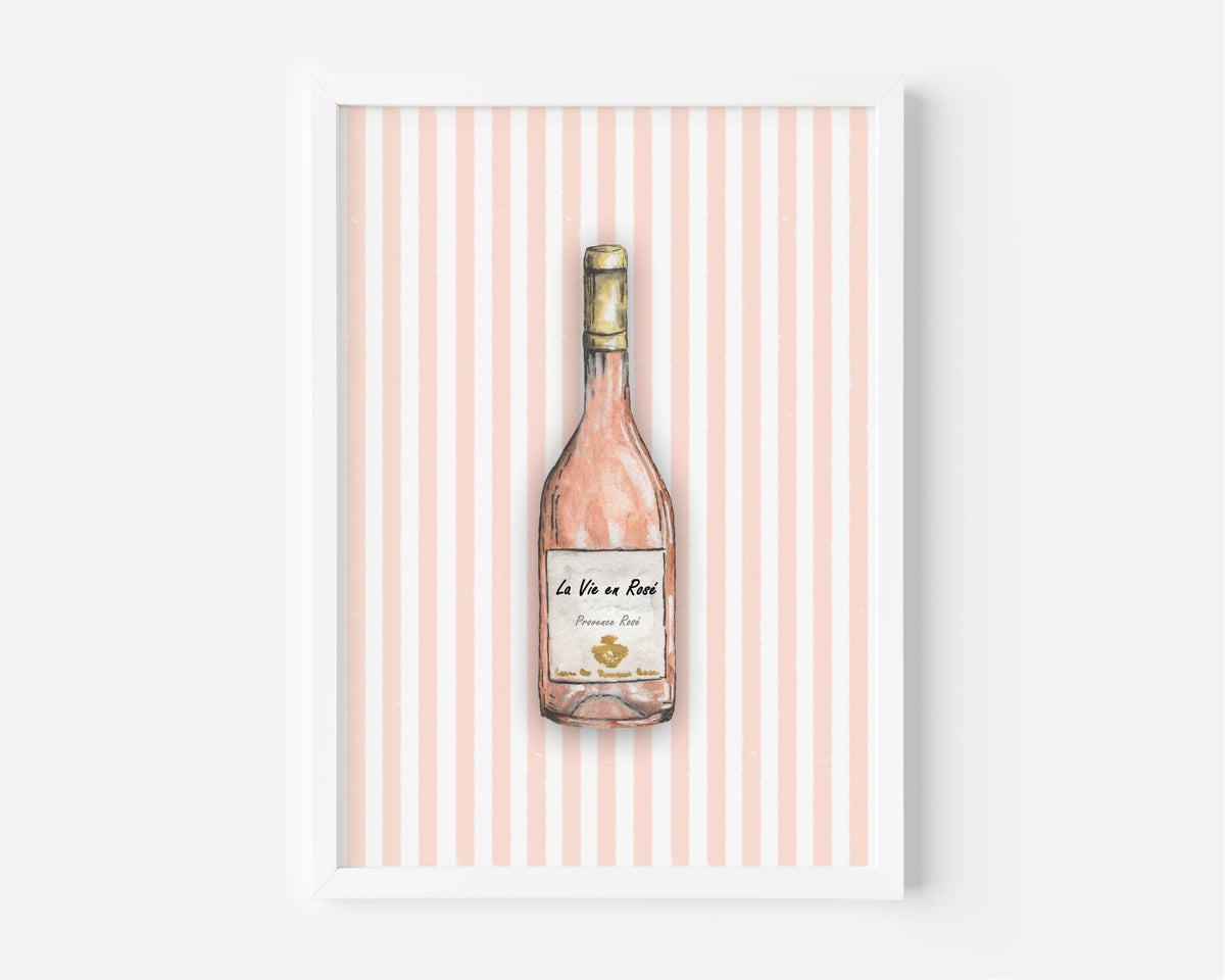 A framed art print featuring a watercolor illustration of a pink wine bottle centered on a background of vertical light pink and white stripes.