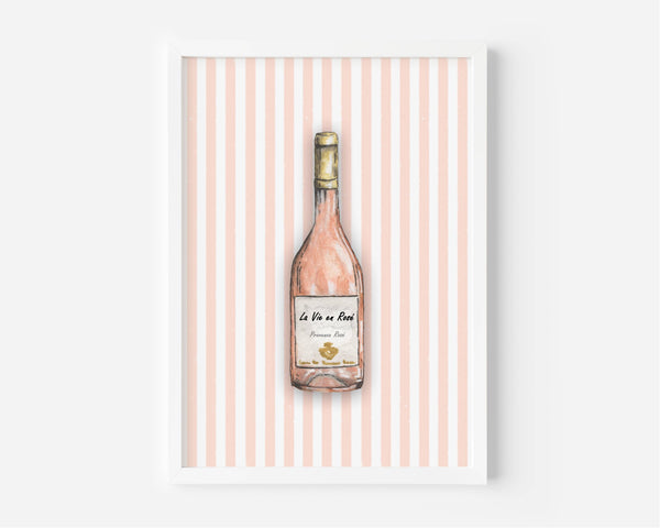 A framed art print featuring a watercolor illustration of a pink wine bottle centered on a background of vertical light pink and white stripes.