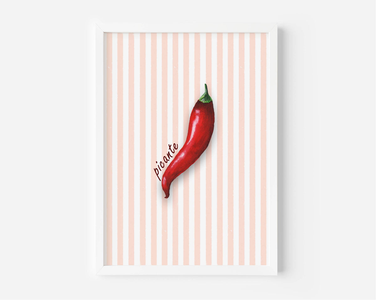 A framed art print featuring a single red chili pepper on a background of vertical peach and white stripes, with the word 'picante' written in cursive next to it.