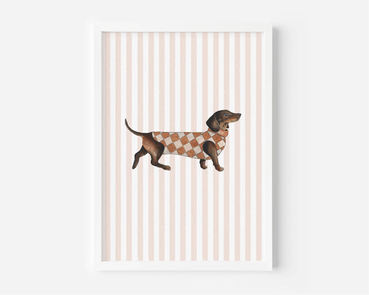 A framed art print featuring a brown dachshund wearing a brown and beige argyle sweater, set against a background of vertical light pink and white stripes.