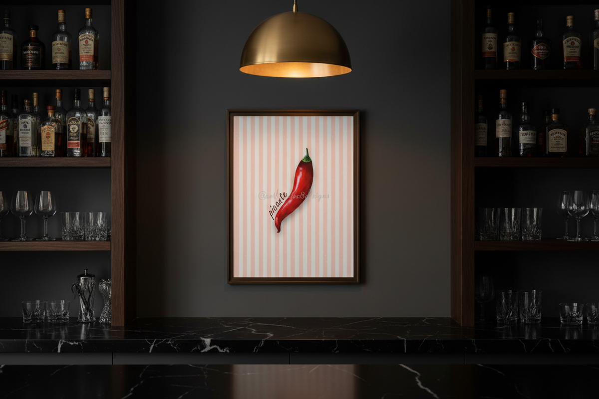 A framed wall art print featuring a single red chili pepper on a white striped background, hanging on a dark gray wall in a bar setting with shelves of bottles and glasses.