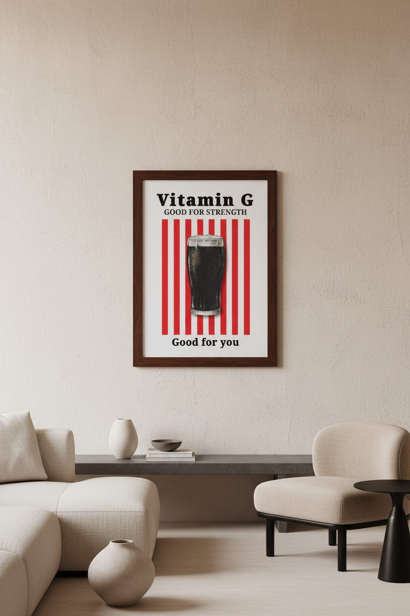 A framed poster with red and white vertical stripes and a dark glass illustration, reading 'Vitamin G Good for Strength' and 'Good for you', displayed on a beige wall above a sofa in a modern living room.