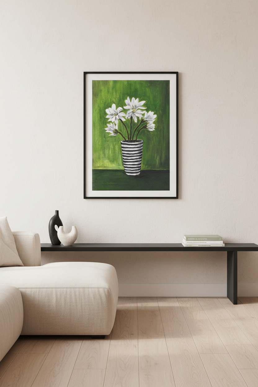 A framed art print depicting white daisy-like flowers in a striped vase against a green background, displayed on a beige wall above a modern black console table and light-colored sofa.